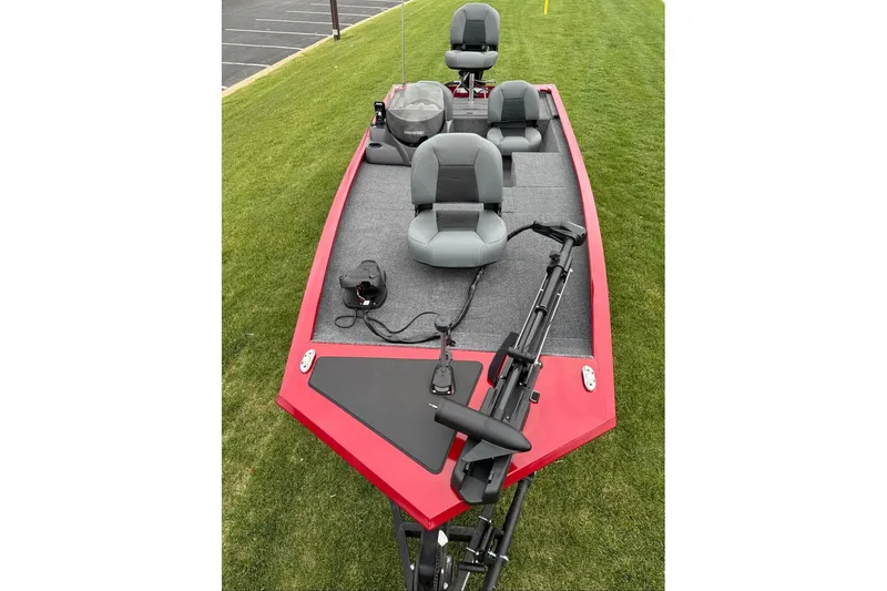 Slide: The Image of Red 2026 Tracker Pro 170 boat with gray seating on grass. - 7