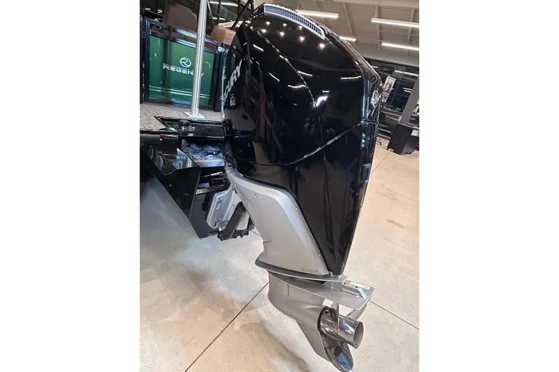 Slide: The Image of 2026 Regency 230 DL boat with Mercury outboard motor in showroom. - 12
