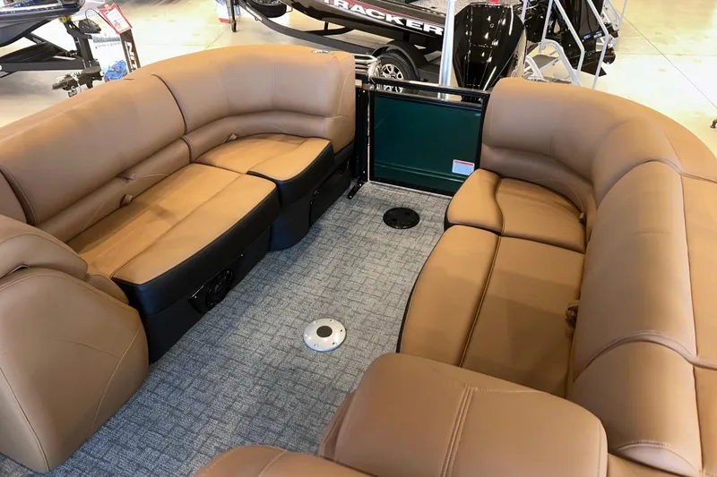 Slide: The Image of Luxurious seating inside a 2026 Regency 230 DL boat, featuring tan upholstery and spacious layout. - 19