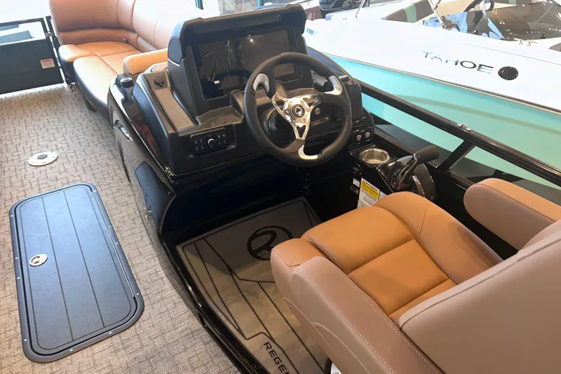 Slide: The Image of 2026 Regency 230 DL boat interior with steering wheel and tan seating. - 20