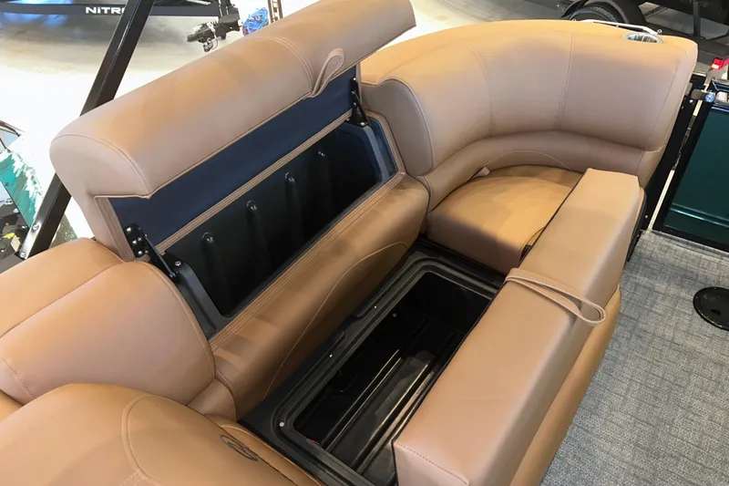 Slide: The Image of Luxurious seating with storage on 2026 Regency 230 DL boat, featuring tan upholstery and modern design. - 24