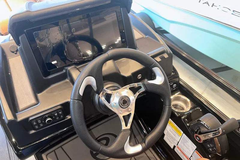 Slide: The Image of Steering console of 2026 Regency 230 DL boat with modern controls and display. - 25