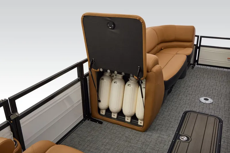 Slide: The Image of Luxurious tan leather seating with storage compartment in 2026 Regency 230 DL boat. - 32