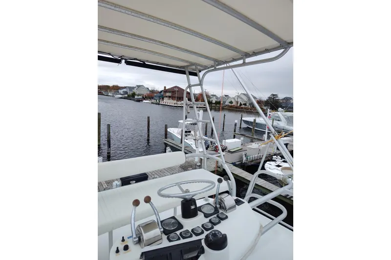 Slide: The Image of 1998 Luhrs 36 SX Open boat helm with marina view in the background. - 12