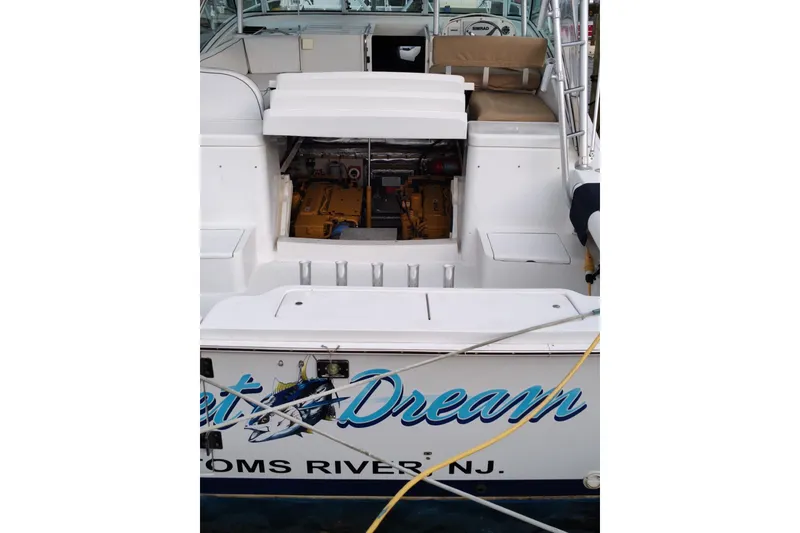 Slide: The Image of 1998 Luhrs 36 SX Open boat with visible engine compartment, docked in Toms River, NJ. - 14