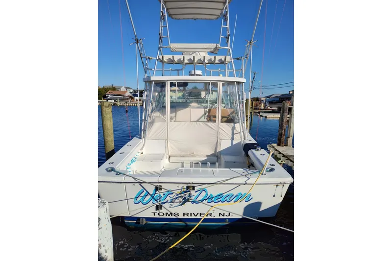 Slide: The Image of 1998 Luhrs 36 SX Open boat docked in Toms River, NJ marina. - 2