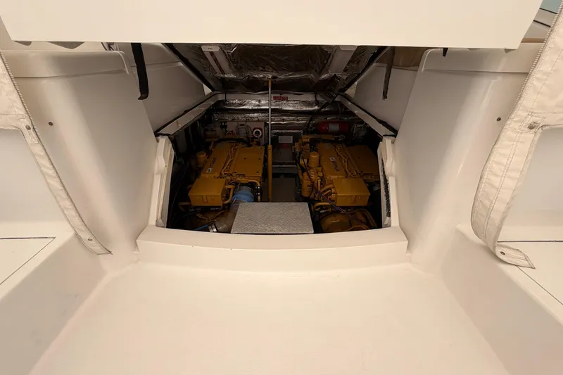 Slide: The Image of Engine compartment of a 1998 Luhrs 36 SX Open boat, featuring dual engines. - 21