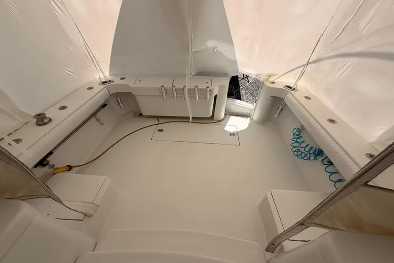 Slide: The Image of 1998 Luhrs 36 SX Open boat interior with white seating and fishing rod holders. - 24