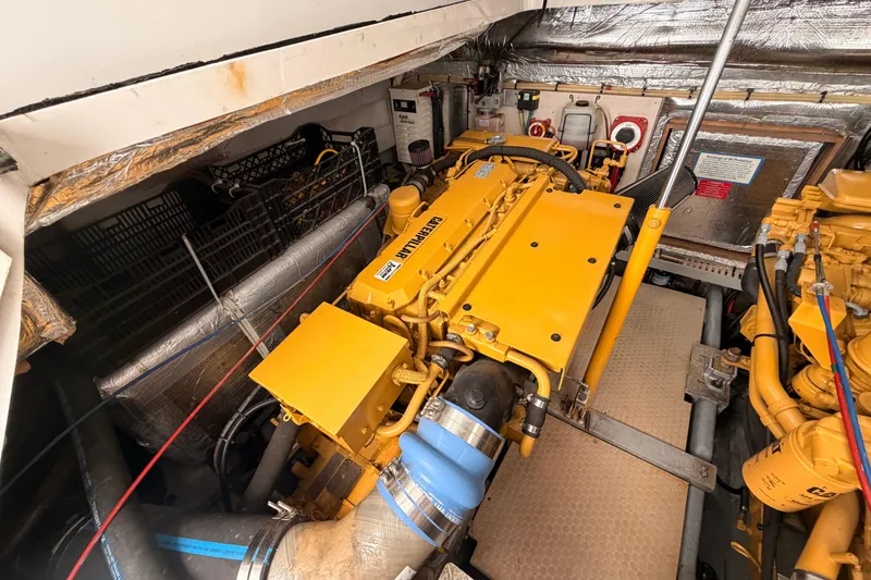Slide: The Image of Engine room of a 1998 Luhrs 36 SX Open boat with yellow machinery. - 26