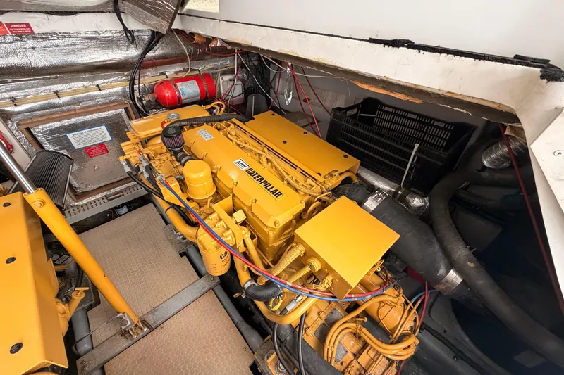 Slide: The Image of Engine room of 1998 Luhrs 36 SX Open with Caterpillar engine and fire extinguisher. - 27