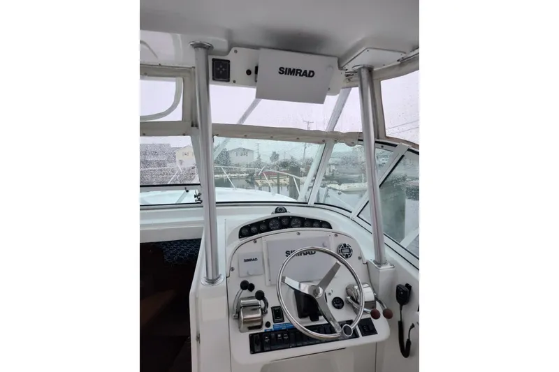 Slide: The Image of 1998 Luhrs 36 SX Open boat helm with Simrad electronics and steering wheel. - 4