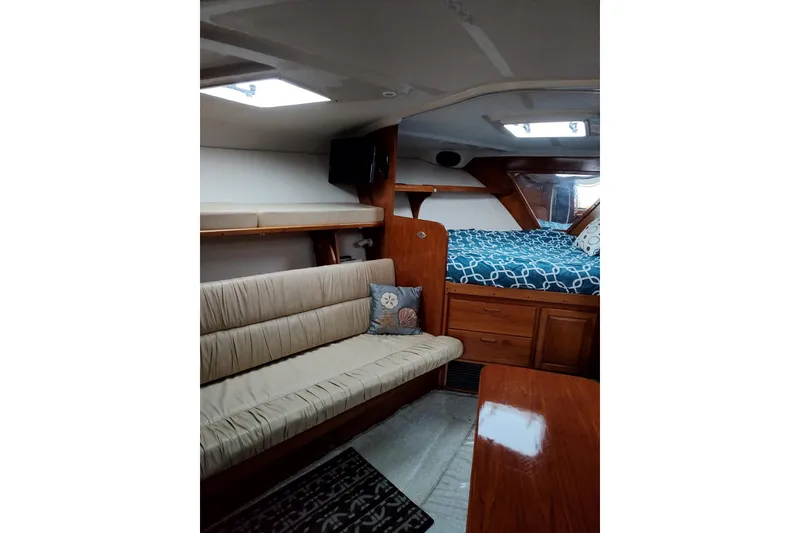 Slide: The Image of Interior of 1998 Luhrs 36 SX Open yacht with cozy seating and bed area. - 6