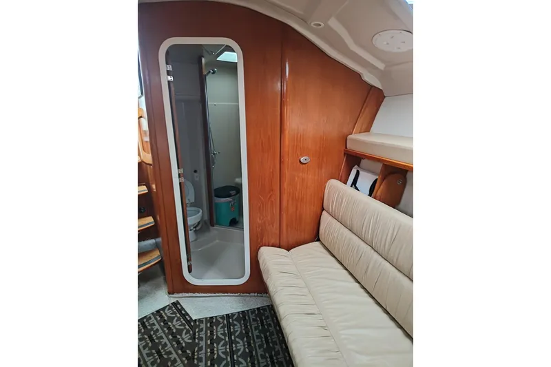 Slide: The Image of 1998 Luhrs 36 SX Open cabin interior with sofa, wooden paneling, and bathroom. - 8