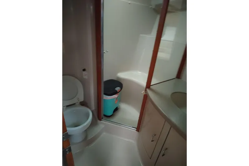 Slide: The Image of Bathroom interior of 1998 Luhrs 36 SX Open boat, featuring toilet and shower. - 9