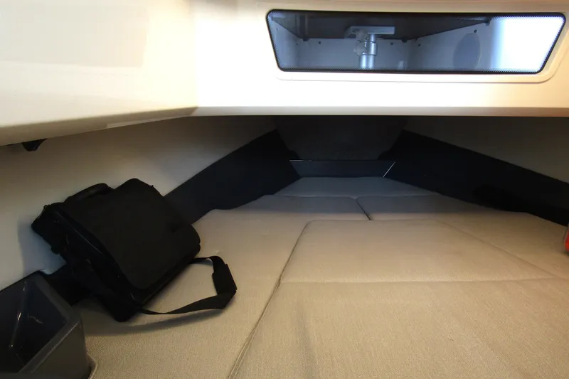 Slide: The Image of 2023 Windy SR28 CC cabin interior with beige seating and storage compartment. - 15