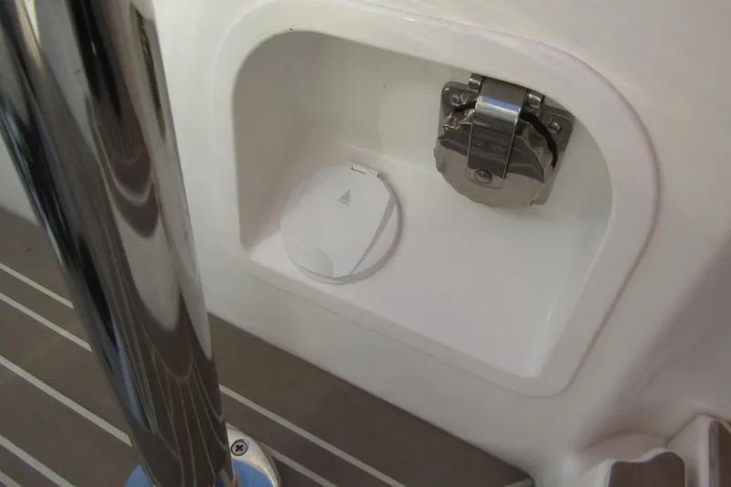 Slide: The Image of 2023 Windy SR28 CC boat compartment with metal latch and cover. - 21