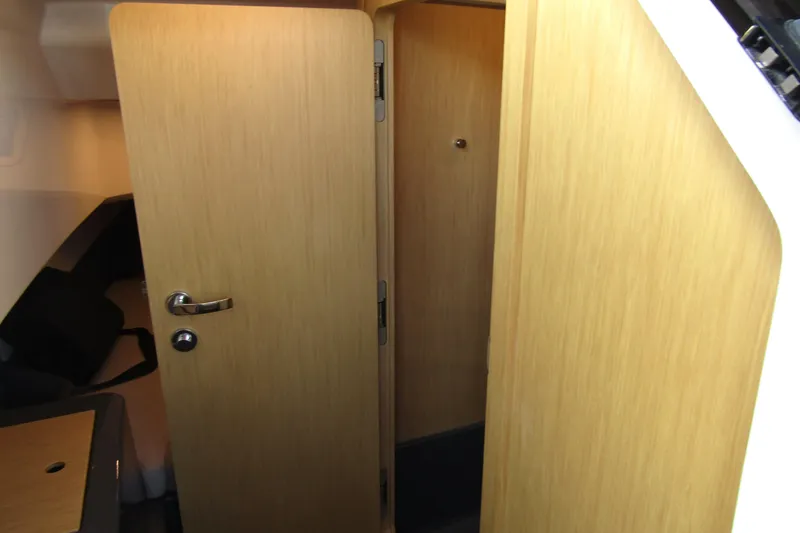 Slide: The Image of Interior cabin view of 2023 Windy SR28 CC, featuring wooden doors and modern design. - 17