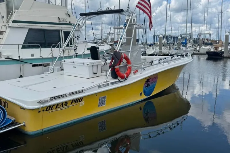 Slide: The Image of Yellow 2021 OceanPro 35 CWS boat docked in marina with American flag. - 9