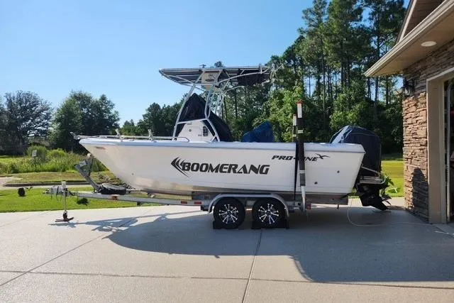 The Image of 2007 Pro-Line 20 Sport boat on trailer, parked outdoors near trees. - 0