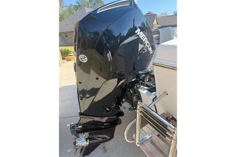 Slide: The Image of 2007 Pro-Line 20 Sport boat with a Mercury outboard motor, parked outdoors. - 10