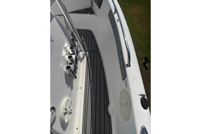 Slide: The Image of 2007 Pro-Line 20 Sport boat deck with rod holders and non-slip flooring. - 11