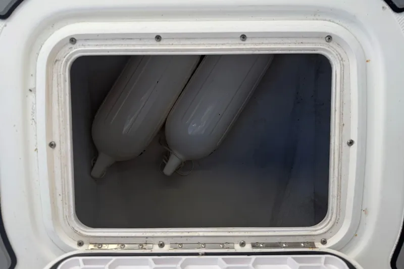 Slide: The Image of Storage compartment with fenders on a 2007 Pro-Line 20 Sport boat. - 14