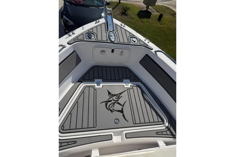 Slide: The Image of 2007 Pro-Line 20 Sport boat deck with custom non-slip flooring and marlin design. - 17