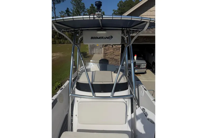 Slide: The Image of 2007 Pro-Line 20 Sport boat with T-top and Boomerang storage, parked in driveway. - 18