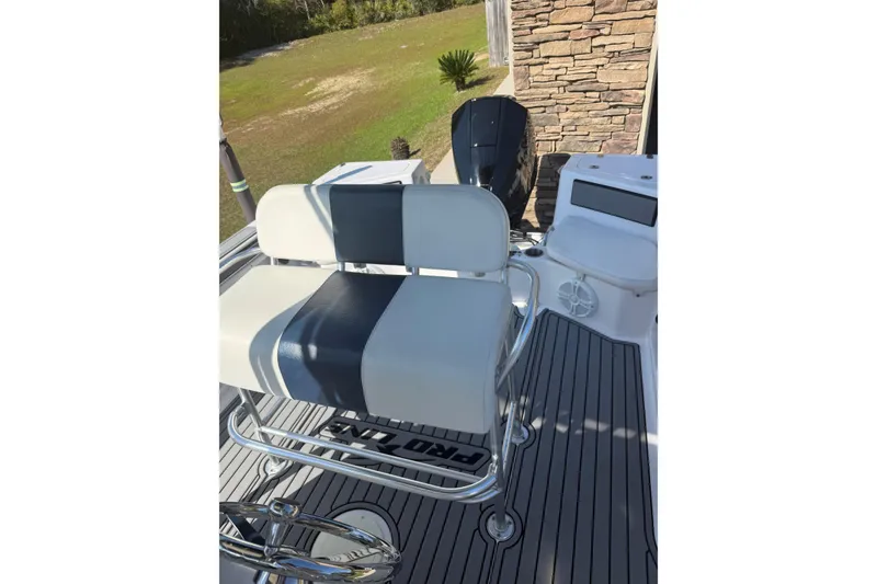 Slide: The Image of 2007 Pro-Line 20 Sport boat interior with striped seating and outboard motor. - 19