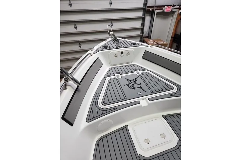 Slide: The Image of 2007 Pro-Line 20 Sport boat interior with custom deck design in a garage. - 2