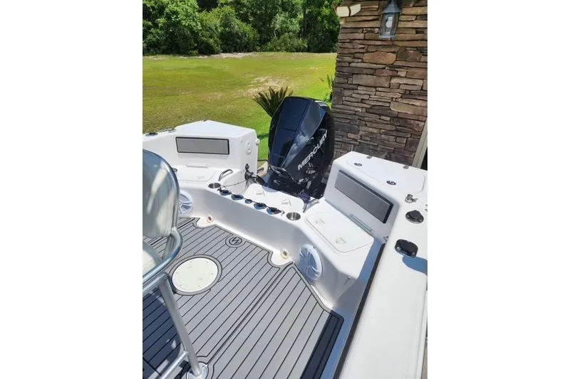Slide: The Image of 2007 Pro-Line 20 Sport boat with Mercury outboard motor, docked near stone wall. - 4