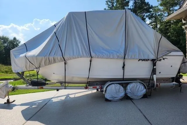 Slide: The Image of 2007 Pro-Line 20 Sport boat covered on trailer, parked outdoors. - 6