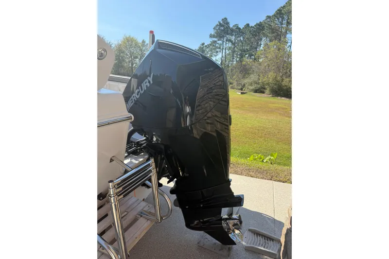 Slide: The Image of 2007 Pro-Line 20 Sport boat with Mercury outboard motor in a sunny outdoor setting. - 7