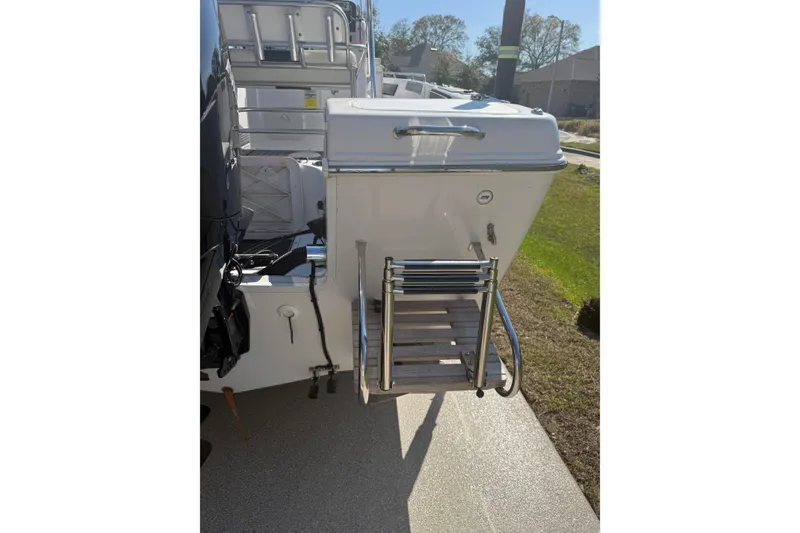 Slide: The Image of 2007 Pro-Line 20 Sport boat with rear ladder and motor, parked outdoors. - 9