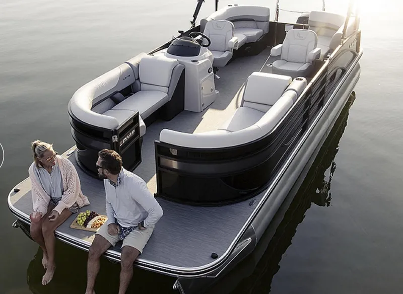 Slide: The Image of 2025 Lowe SS230WV pontoon boat on water with two people relaxing onboard. - 10