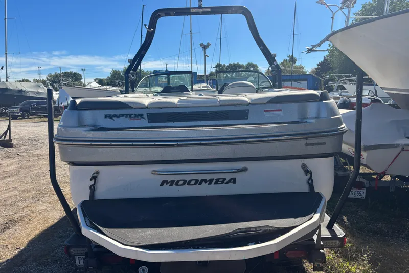 Slide: The Image of 2016 Moomba Craz boat with Raptor engine, parked outdoors on a sunny day. - 10