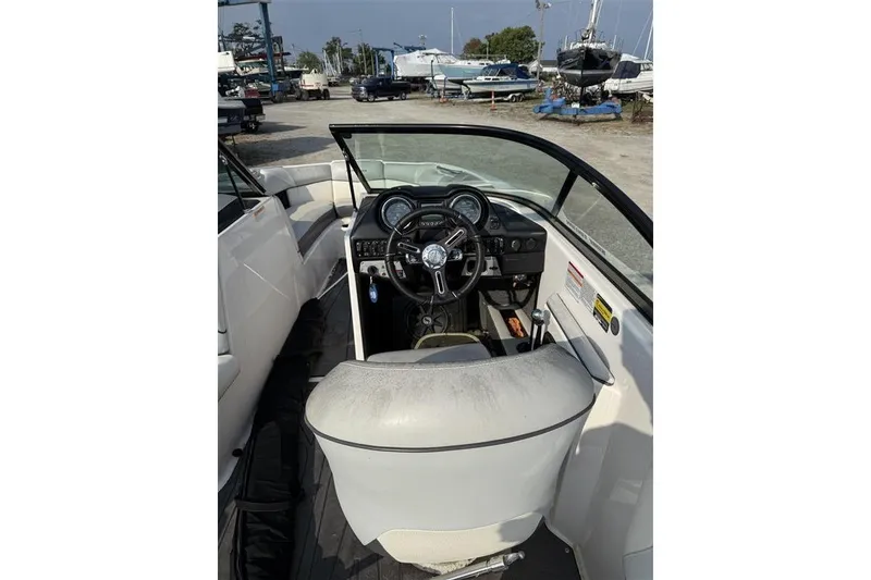 Slide: The Image of 2016 Moomba Craz boat interior with steering wheel and dashboard view. - 13