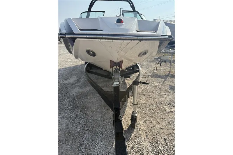 Slide: The Image of 2016 Moomba Craz boat on trailer, front view, parked on gravel. - 14