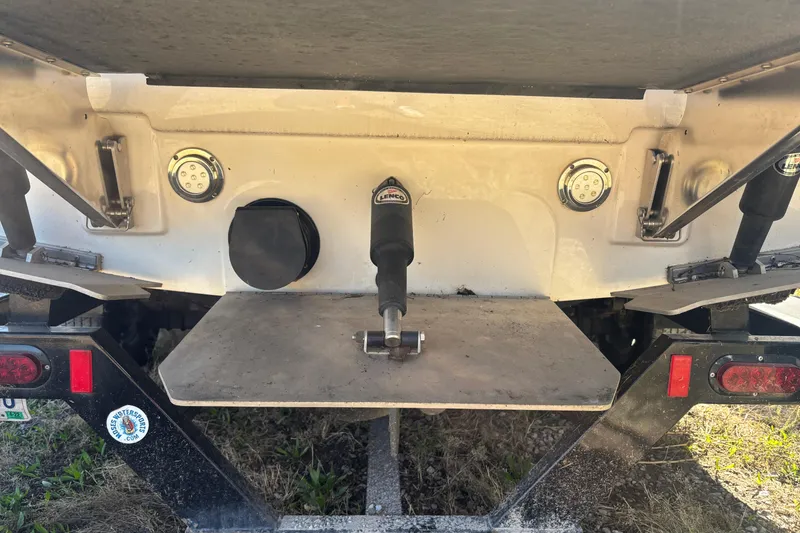 Slide: The Image of 2016 Moomba Craz boat rear view with trim tabs and trailer details. - 15