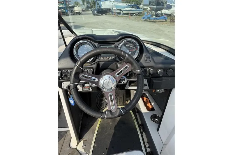 Slide: The Image of Steering wheel and dashboard of a 2016 Moomba Craz boat. - 3
