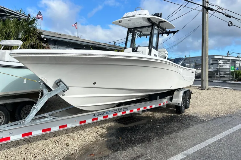 The Image of 2026 Sea Fox 282 Hybrid LT boat on trailer, parked outdoors under cloudy sky. - 0