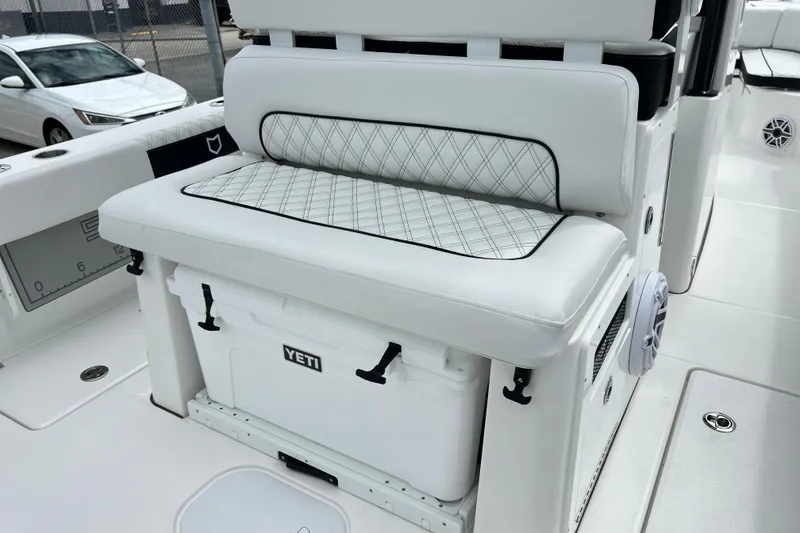 Slide: The Image of 2026 Sea Fox 282 Hybrid LT boat interior with cushioned seating and Yeti cooler. - 13