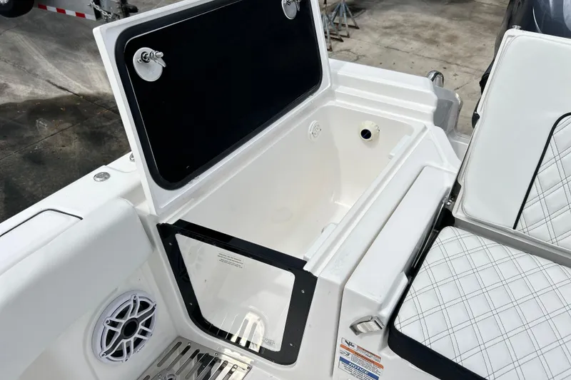 Slide: The Image of Open storage compartment on 2026 Sea Fox 282 Hybrid LT boat, featuring cushioned seating and speaker. - 16