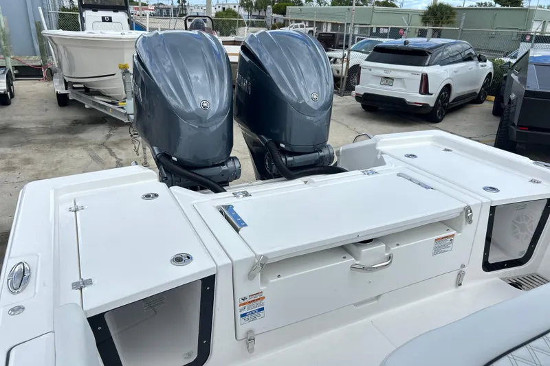 Slide: The Image of 2026 Sea Fox 282 Hybrid LT boat with dual outboard engines in a marina setting. - 19