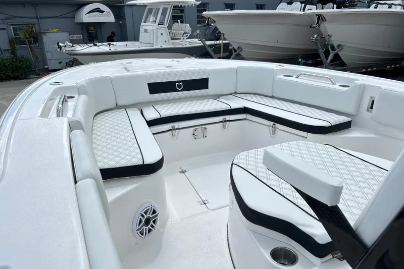 Slide: The Image of 2026 Sea Fox 282 Hybrid LT boat interior with white cushioned seating and modern design. - 2