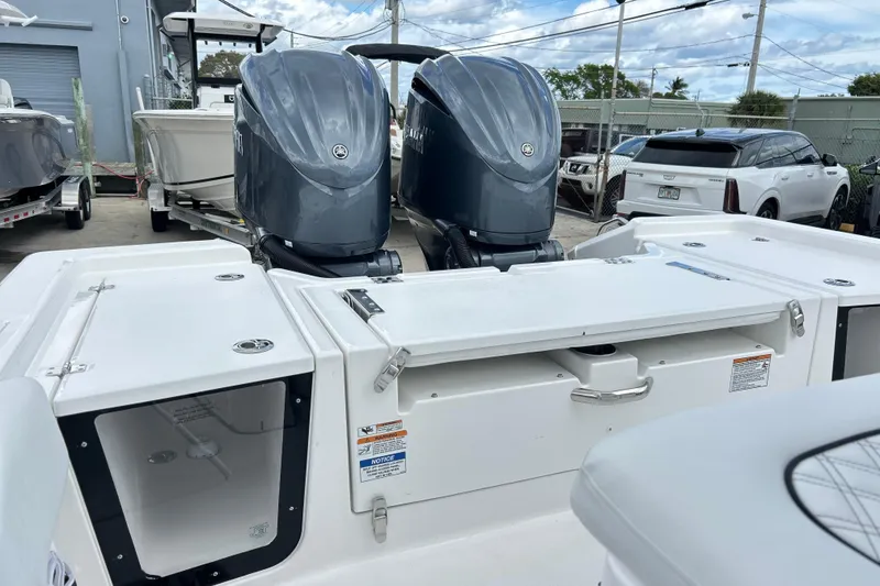 Slide: The Image of 2026 Sea Fox 282 Hybrid LT boat with dual outboard motors in a marina setting. - 20