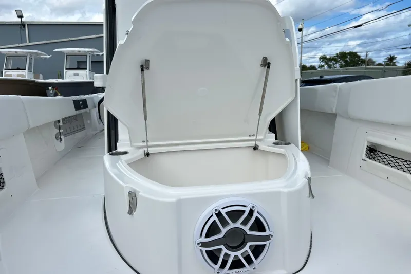 Slide: The Image of 2026 Sea Fox 282 Hybrid LT boat interior with open storage compartment and speaker. - 37