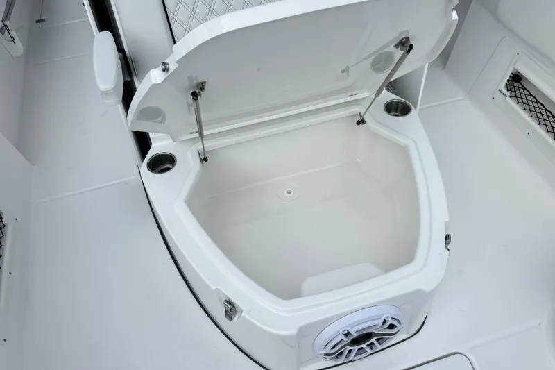 Slide: The Image of Open storage compartment on 2026 Sea Fox 282 Hybrid LT boat, featuring cup holders and speaker. - 38