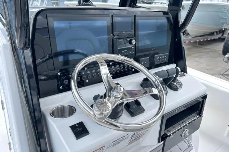 Slide: The Image of 2026 Sea Fox 282 Hybrid LT boat dashboard with modern controls and steering wheel. - 5