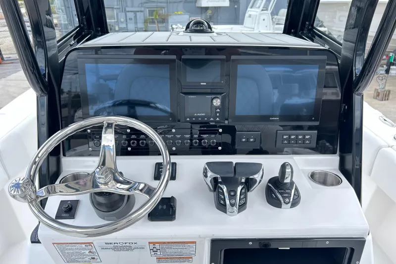 Slide: The Image of 2026 Sea Fox 282 Hybrid LT boat dashboard with steering wheel and electronic controls. - 6